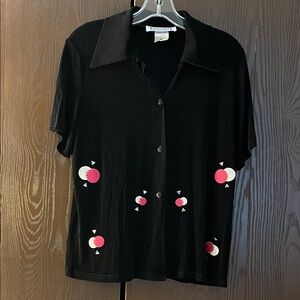 Kokomo short sleeved black blouse with attached pieces for design. Size XL
